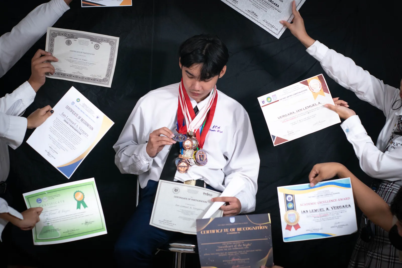 Ian surrounded by certificates and medals